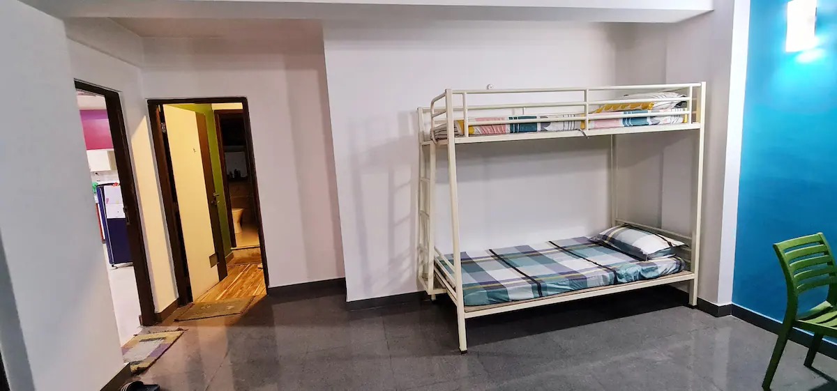 Bunk Bed Room Wide View with Open Doorway to Bathroom