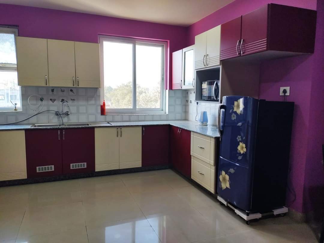 Kitchen Wide Angle — Purple Walls, L-Shaped Cabinets & Blue Fridge